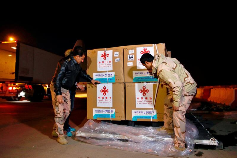 Air freight workers examine the consignment of the Sinopharm vaccine at Baghdad International Airport, Baghdad. Iraq has an arrangement with Sinopharm to supply two million doses. AP Photo