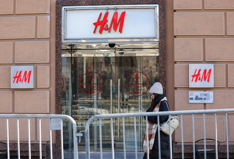 A woman walks past a closed H&M store in Moscow. Reuters