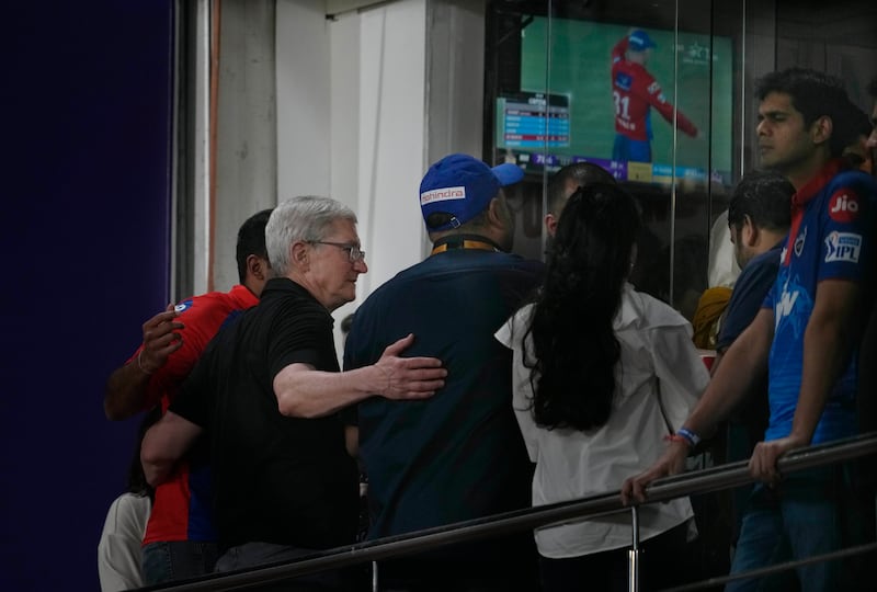 Apple chief Tim Cook poses for photographs with fans at the Arun Jaitley Stadium in Delhi. AP