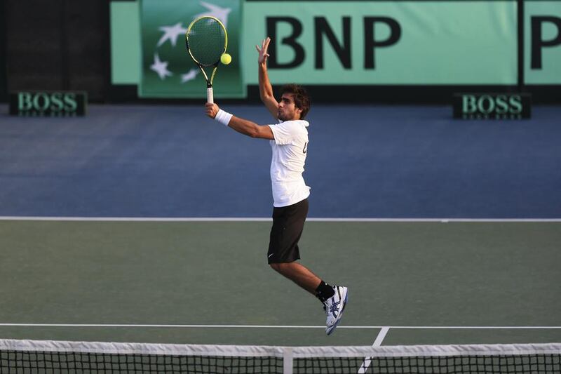 Hamad Janahi of the UAE leaps to return a volley from Hoang Thien Nguyen of Vietnam during their  Davis Cup qualifying match at Dubai. Sarah Dea / The National