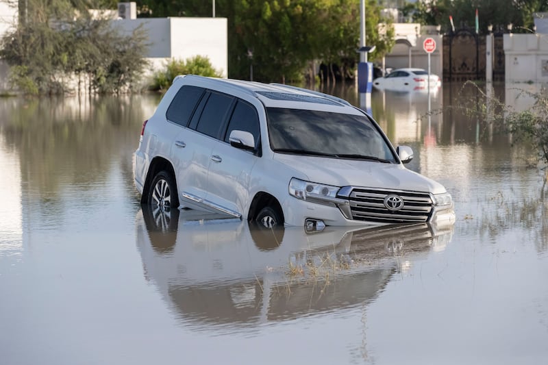 An abandoned car is partly submerged on Sheikh Zayed Road in Dubai. Antonie Robertson / The National