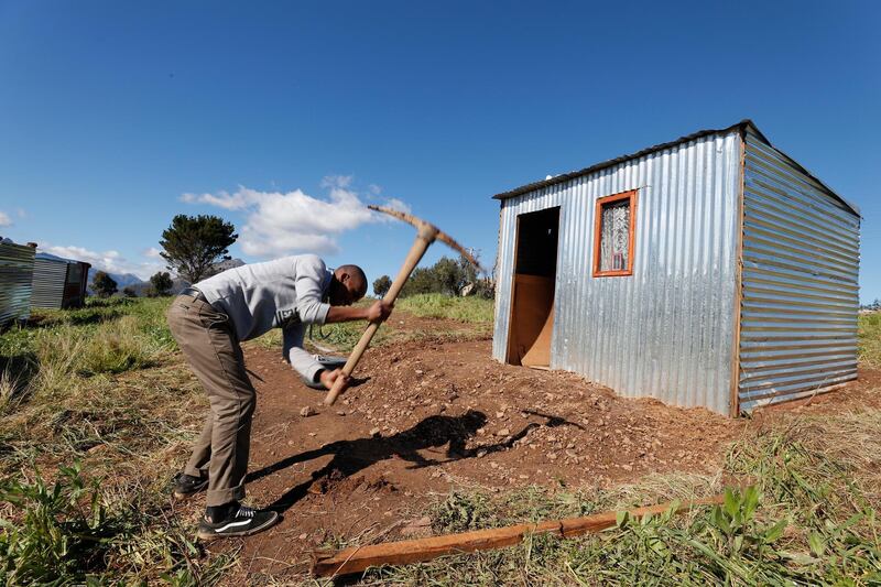 epa06966365 (FILE) - A South African man builds an illegally erected shack during a land invasion on the property of Louiesenhof Wine farm in the heart of the major wine producing region of Stellenbosch, South Africa, 08 August 2018 (reissued 23 August 2018). According to reports, South African Minister of International Relations and Cooperation, Lindiwe Sisulu wants to communicate with US Secretary of State Pompeo over 'regrettable' remarks US President Donald J. Trump made on South Africa's land reform plans. A major debate around land expropriation without compensation is being waged in the country at present. Parliamentarians are currently debating to amend the constitution to allow for land expropriation.  EPA/NIC BOTHMA