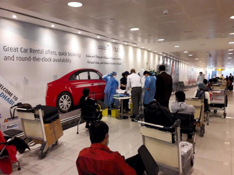 Passengers wait for the flights at Dubai International Airport on Thursday. Indian Consulate