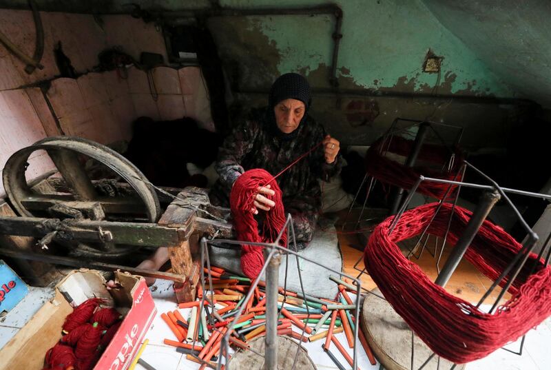 Madiha Alkhouly, 76, weaves a traditional Egyptian rug at a textile workshop in the village of Atmida, in Dakahliya governorate, Egypt. Reuters