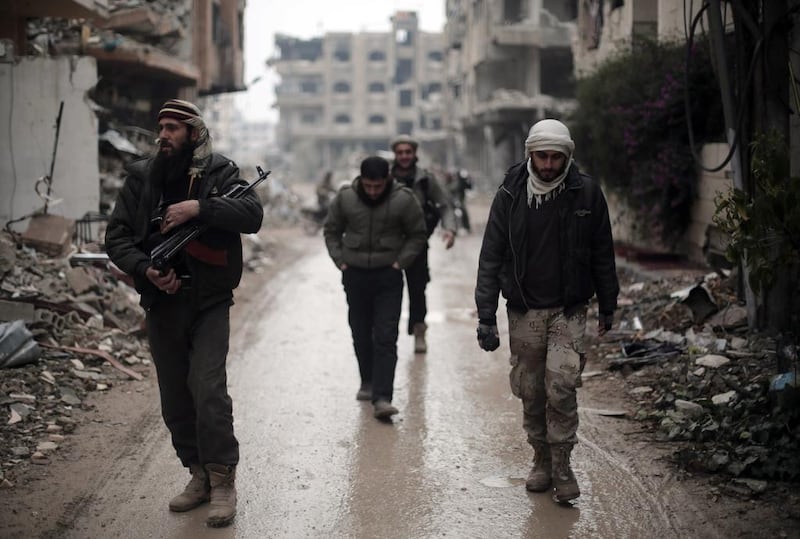 Fighters from Jaish Al Islam patrol the front line in Jobar, on the eastern edge of the Syrian capital, on January 4, 2016. Amer Almohibany/AFP Photo 

