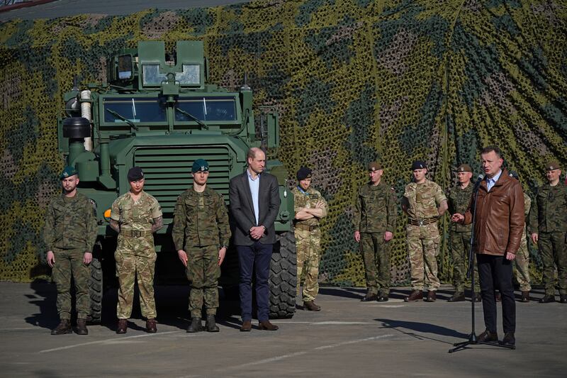 Prince William listens as Mr Blaszczak makes a speech in Warsaw. Getty 