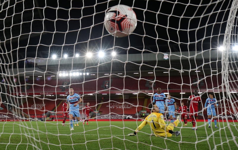 LIVERPOOL, ENGLAND - OCTOBER 31: Diogo Jota of Liverpool  scores his team's second goal  during the Premier League match between Liverpool and West Ham United at Anfield on October 31, 2020 in Liverpool, England. Sporting stadiums around the UK remain under strict restrictions due to the Coronavirus Pandemic as Government social distancing laws prohibit fans inside venues resulting in games being played behind closed doors. (Photo by Clive Brunskill/Getty Images)