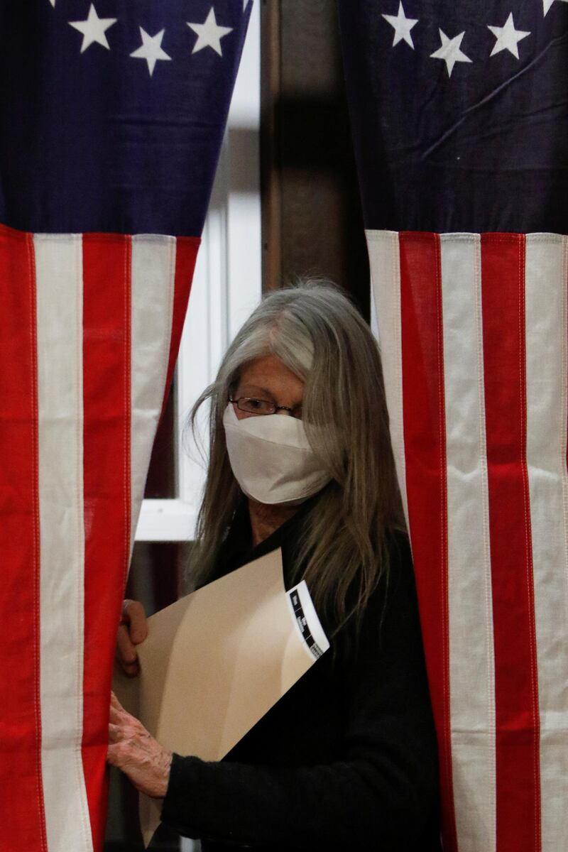 Debra Tillotson prepares to cast a ballot shortly after midnight for the U.S. presidential election at the Hale House at Balsams Hotel in the hamlet of Dixville Notch, New Hampshire. Reuters