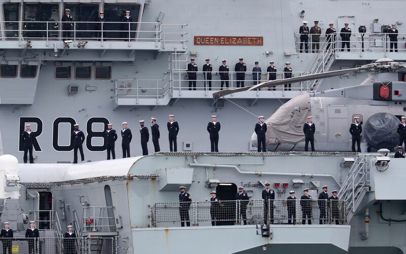 Ship's company line the side of the Royal Navy aircraft carrier HMS Queen Elizabeth as it leaves Portsmouth Naval Base. Getty Images