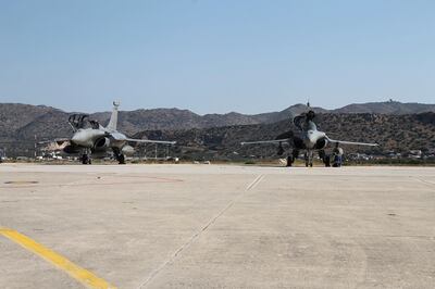 In this photo provided by the Greek National Defense, two French Rafale fighter jets at Souda airbase on the island of Crete, Thursday, Aug. 13, 2020. Greece's prime minister warmly thanked France Thursday for its decision to boost its military presence in the eastern Mediterranean, where Greek and Turkish warships are closely shadowing each other over a Turkish energy exploration bid in waters Athens claims as its own. (Hellenic National Defense via AP)