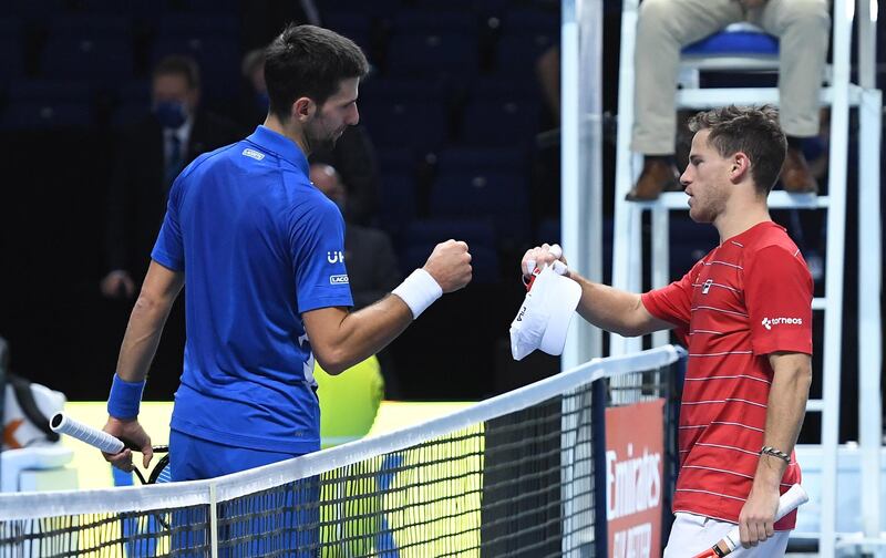 Novak Djokovic and Diego Schwartzman bump fists after their group stage match. EPA