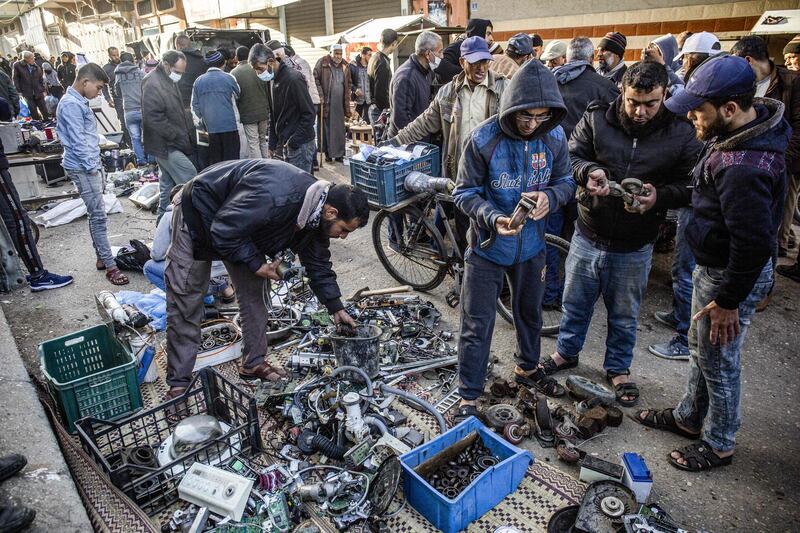 Moamen Abu Raida, 29, a Palestinian technician, searches for spare parts at a scrap market in Bani Suhaila, a town east of Khan Younis in southern Gaza. Using discarded materials and rudimentary equipment at a cost of 850 shekels (US$261), Abu Raida builds small electric vehicles used by the elderly and people with disabilities. AFP