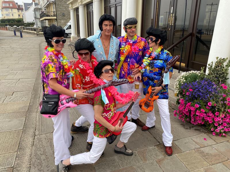 Elvis fans in fancy dress surround tribute act Ricky Jenkins on the seafront in Porthcawl.