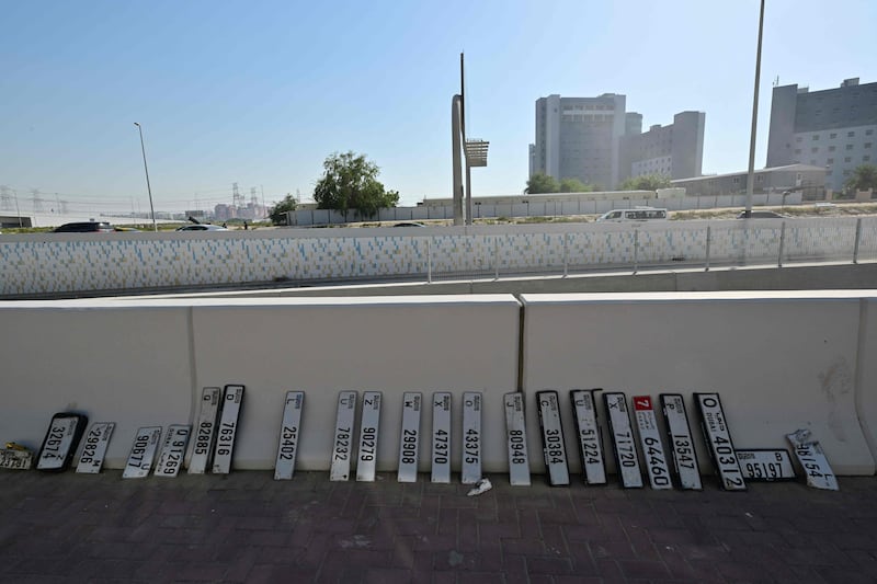 Recovered car number plates are lined up at the side of a road in Dubai on April 19 after heavy rain caused widespread flooding. AFP