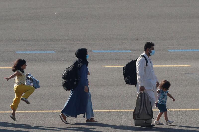 People evacuated from Afghanistan arrive at Melsbroek military airport in Belgium, on August 25.  Reuters