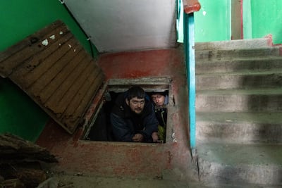 People hide in an improvised bomb shelter in Mariupol. AP Photo