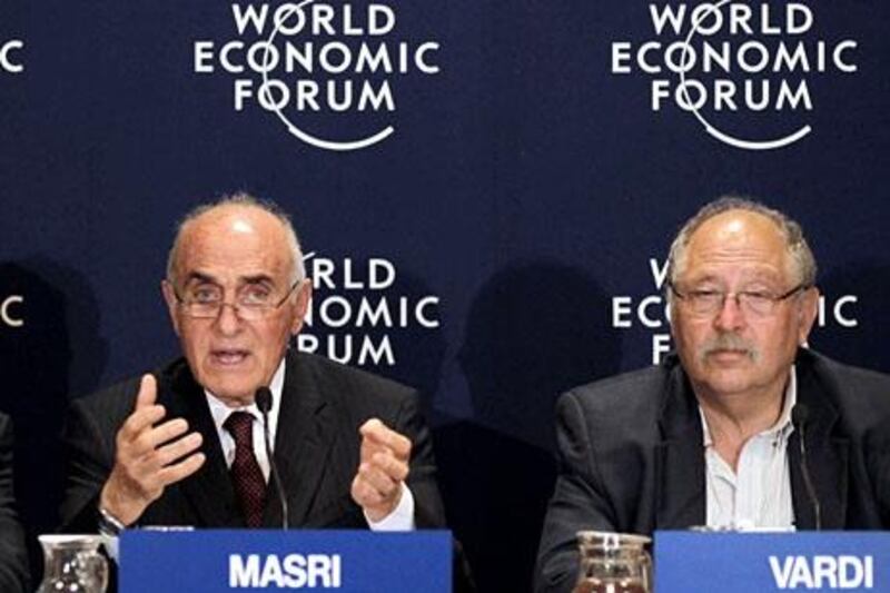 Munib al-Masri chairman of the Palestine Development and Investment Company (Padico) speaks as Israeli Yossi Vardi chairman of International Technologies listens on at the World Economic Forum on the Middle East and North Africa on the shores of the Dead Sea, 55 kms southeast of the Jordanian capital Amman, on May 26, 2013. AFP PHOTO/KHALIL MAZRAAWI

 *** Local Caption ***  203037-01-08.jpg