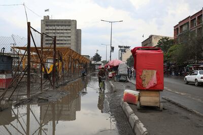 Street vendors carts on waterlogged street on a rainy day in Kabul. Mahab Azizi for The National