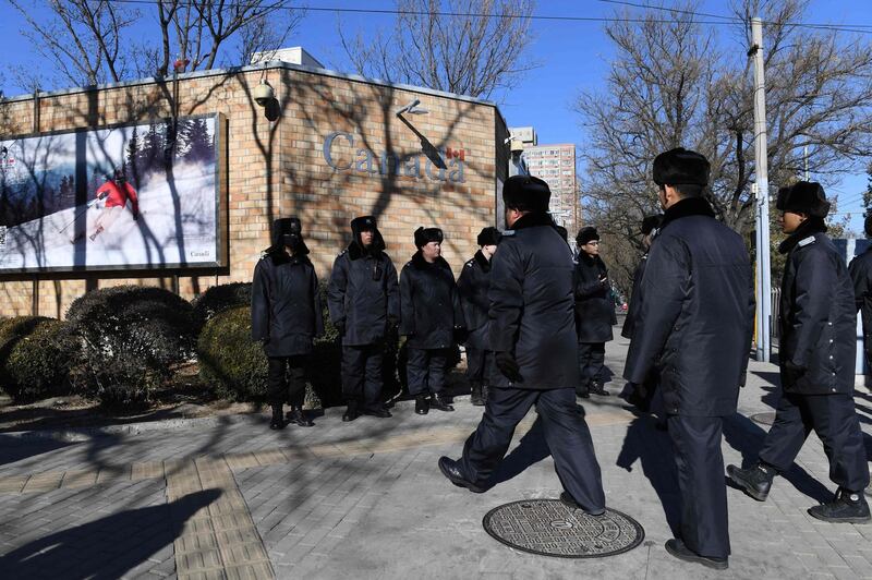 Chinese police patrol in front of the Canadian embassy in Beijing on December 13, 2018. A second Canadian who had gone missing in China is under investigation on suspicion of "engaging in activities that harm China's national security", state media reported on December 13. Security has been stepped up outside the embassy since Meng Wanzhou, the chief financial officer of Chinese telecom giant Huawei, was arrested in Canada, at Washington's request. / AFP / GREG BAKER
