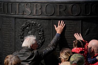 People place their hands on the Hillsborough memorial outside Liverpool's Saint George's Hall. Getty Images