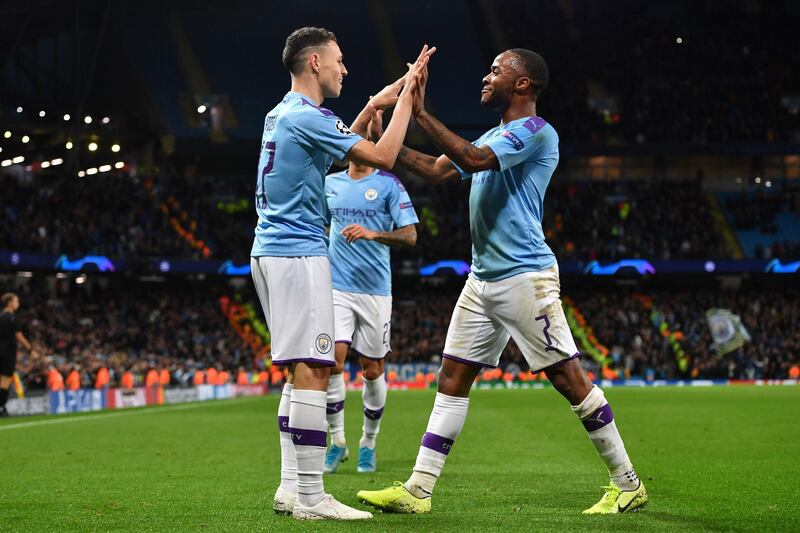 Phil Foden celebrates with Raheem Sterling after scoring Manchester City's second goal. AFP