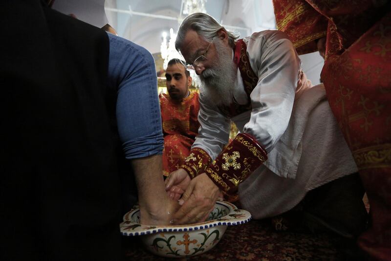 A Christian Orthodox bishop washes the feet of a man during a mass of holy week at the Panayia Faneromeni Orthodox Church capital Nicosia, Cyprus. AFP