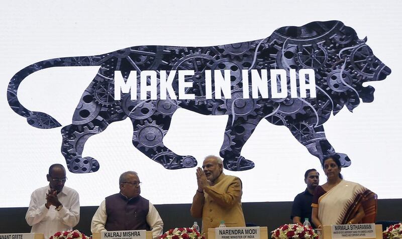 India's Prime Minister Narendra Modi, centre, gestures at the 'Make in India' campaign. Adnan Abidi / Reuters