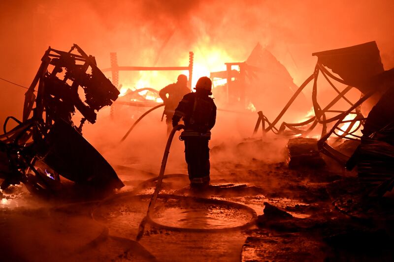 Ukrainian firefighters battle flames after a Russian drone attack on industrial facilities in the city of Kharkiv. AFP