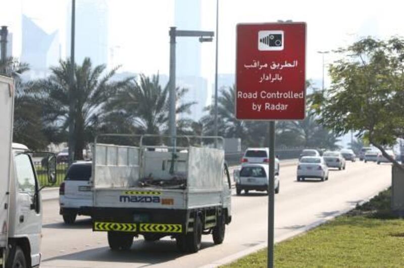 Feb 8, 2011 / Abu Dhabi / Motorist drive along the Corniche past a sign postings warning of speed enforcement, by radar February 8, 2011. (Sammy Dallal / The National)
