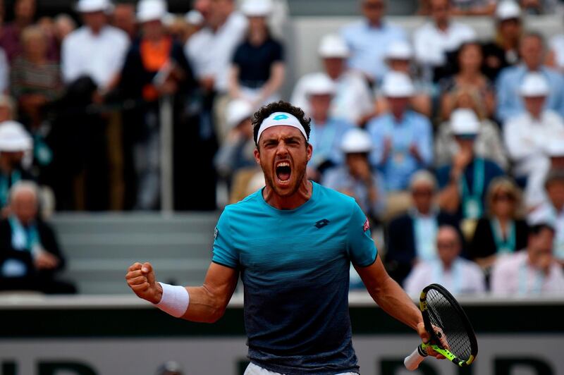 TOPSHOT - Italy's Marco Cecchinato celebrates after a point against Serbia's Novak Djokovic during their men's singles quarter-final match on day ten of The Roland Garros 2018 French Open tennis tournament in Paris on June 5, 2018. / AFP / Eric FEFERBERG
