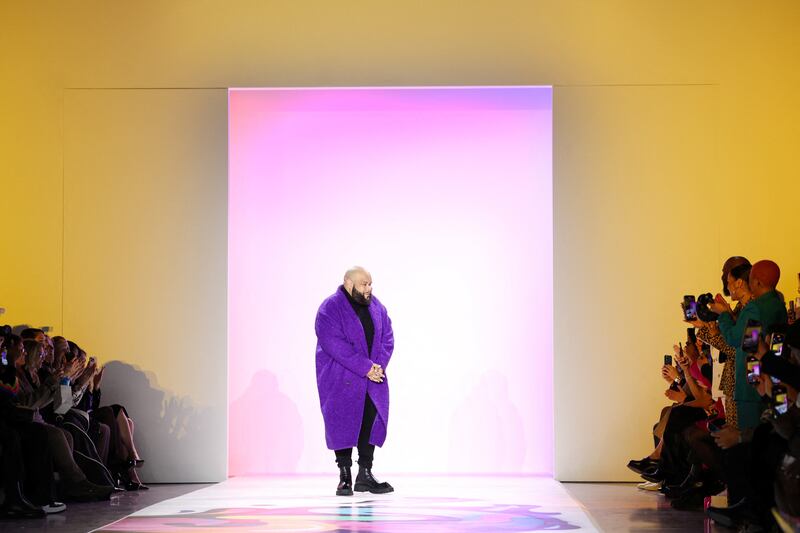 Fashion designer Hudson receives applause after presenting his collection. Reuters