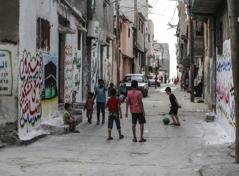 Palestinian refugees pass the time in the Shateaa camp in the north west of Gaza City.  EPA/HAITHAM IMAD