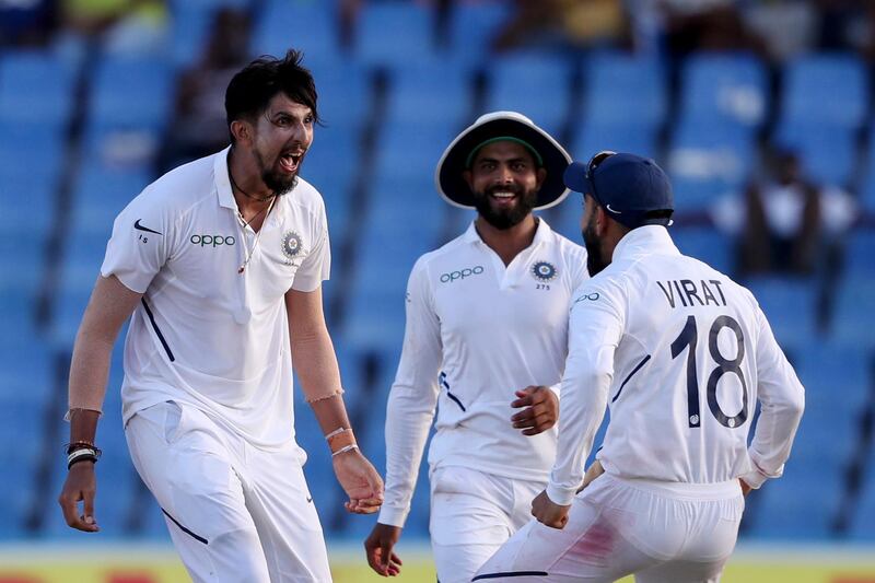 India's Ishant Sharma celebrates with captain Virat Kohli the dismissal of West Indies' Kemar Roach during day two of the first Test cricket match at the Sir Vivian Richards cricket ground in North Sound, Antigua and Barbuda, Friday, Aug. 23, 2019. (AP Photo/Ricardo Mazalan)