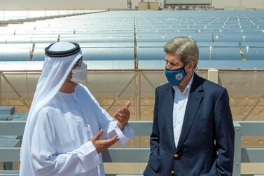 US climate envoy John Kerry speaks with Dr Sultan Al Jaber, UAE special envoy for climate change, at Abu Dhabi's Noor solar park. The National 