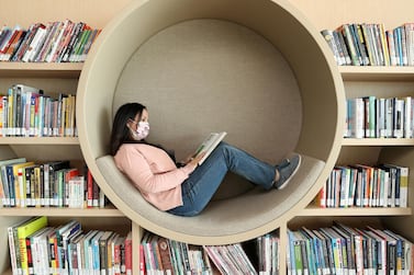 Sharjah, United Arab Emirates - December 10, 2020: News. Arts. Ebtisam Kasabri reads a book in a pod. Opening of the House of Wisdom, a high tech new library. Thursday, December 10th, 2020 in Sharjah. Chris Whiteoak / The National
