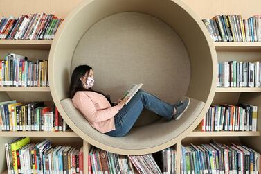 Sharjah, United Arab Emirates - December 10, 2020: News. Arts. Ebtisam Kasabri reads a book in a pod. Opening of the House of Wisdom, a high tech new library. Thursday, December 10th, 2020 in Sharjah. Chris Whiteoak / The National