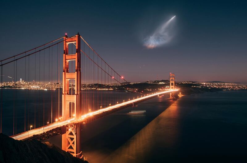 The SpaceX Falcon 9 rocket launch is seen in the distance over the Golden Gate Bridge near Sausalito, California. Justin Borja via AP