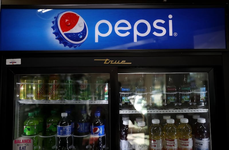 (FILES) In this file photo taken on February 13, 2018, bottles of Pepsi are displayed on a shelf at a convenience store in San Anselmo, California. - Going after consumers concerned about health and the environment, PepsiCo on Monday, August 20, 2018 announced the purchase of Israeli company SodaStream to tap its command of the homemade fizzy water market. With the $3.2 billion purchase, the US beverage giant continues its effort to contend with falling demand for sugar-laden soft drinks, especially sodas. SodaStream makes machines that carbonate home tap water. PepsiCo and arch-rival Coca-Cola have been diversifying away from their mainstay sodas in part to counter the onset of anti-obesity sugar taxes around the world. The acquisition also is a pitch to consumers concerned about mounting waste from soda cans and plastics in landfills around the world, since SodaStream employs reusable bottles. (Photo by JUSTIN SULLIVAN / GETTY IMAGES NORTH AMERICA / AFP)