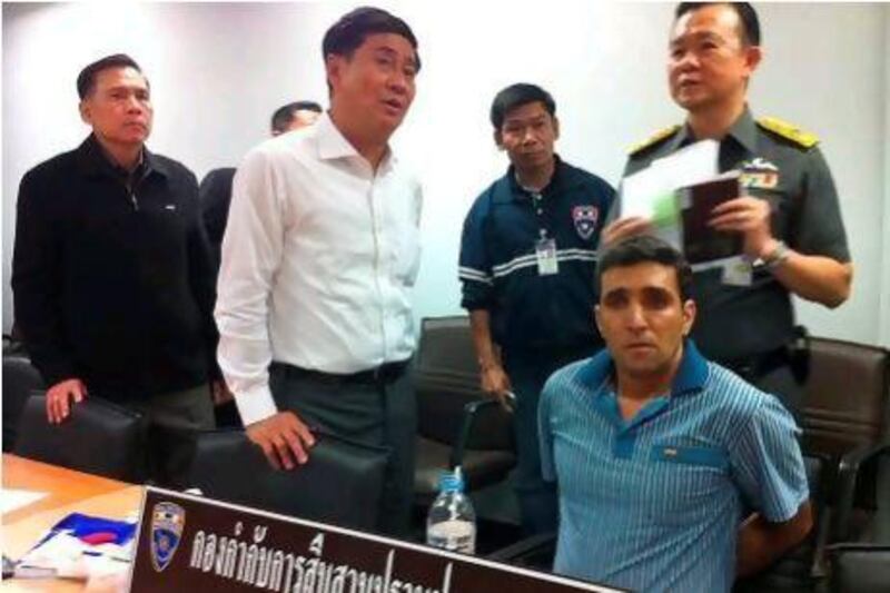 An Iranian bombing suspect, Mohammad Khazaei, sits at an immigration office after he was arrested at Bangkok’s international airport.