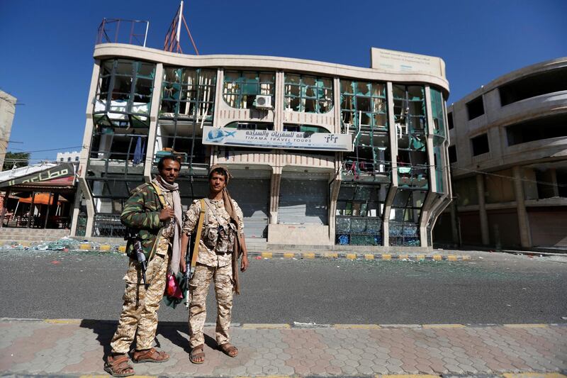 Houthi fighters pose for a photo in front of a damaged building on a street where Houthis have recently clashed with forces loyal to slain Yemeni former president Ali Abdullah Saleh in Sanaa, Yemen December 6, 2017. REUTERS/Khaled Abdullah