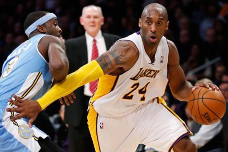 Los Angeles Lakers' Kobe Bryant looks for a way past Denver Nuggets' Ty Lawson.