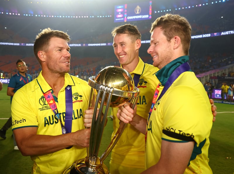 Australia's David Warner, Marnus Labuschagne and Steve Smith celebrate with the trophy. Reuters