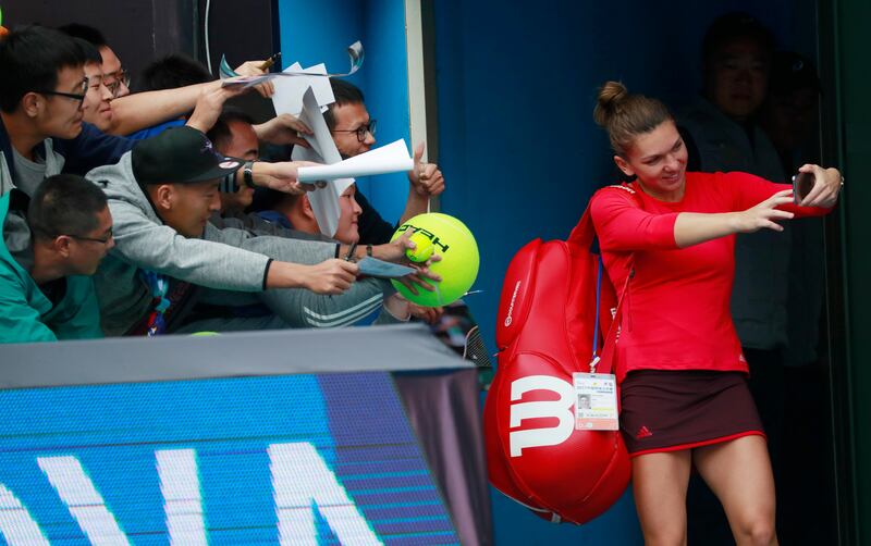 Simona Halep of Romania takes a selfie with fans after her women's singles second round match against Magdalena Rybarikova of Slovakia at the China Open tennis tournament in Beijing, China. How Hwee Young / EPA