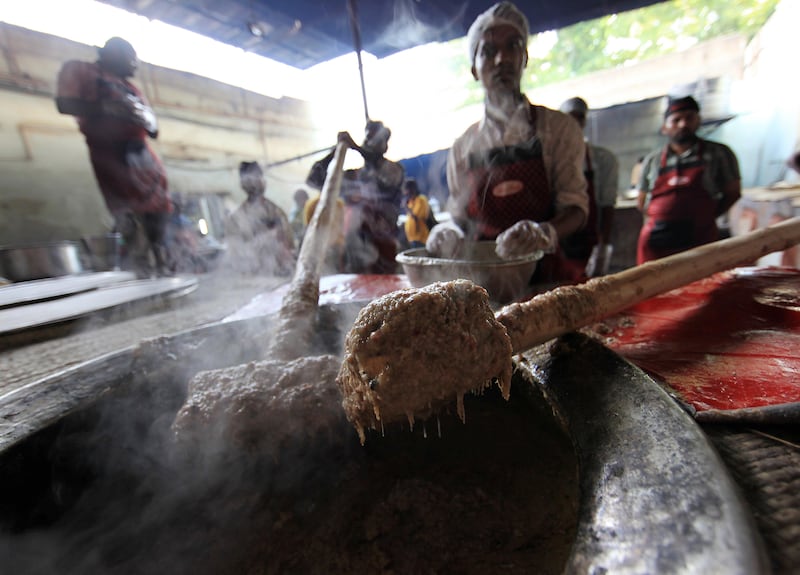 HYDERABAD - INDIA - 01AUG 2012 -  Workers smashing the meat with spices to prepare Haleem at Pista House Haleem, which received a geographical indicator trademark for its haleem, a dish of meat and lentils that it makes particularly during Ramadan on Charminar road in Old Hyderabad City in Andhra Pradesh State in India.  The haleem prepared here is so popular that it is even sent out by post, in response to orders received from across India. Ravindranath K / The National (to go with Samanth story on Ramadan)