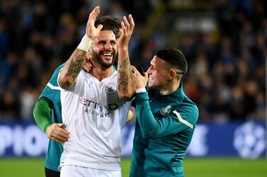 Manchester City's English defender Kyle Walker and team mates celebrate their victory at the end of the UEFA Champions League first round day 3 Group A football match between Club Brugge and Manchester City at the Jan Breydel stadium in Bruges on October 19, 2021.  (Photo by JOHN THYS  /  AFP)