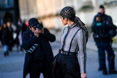 A woman is photographed wearing a Louis Vuitton monogram bandana during Paris Fashion Week 2020. Getty Images