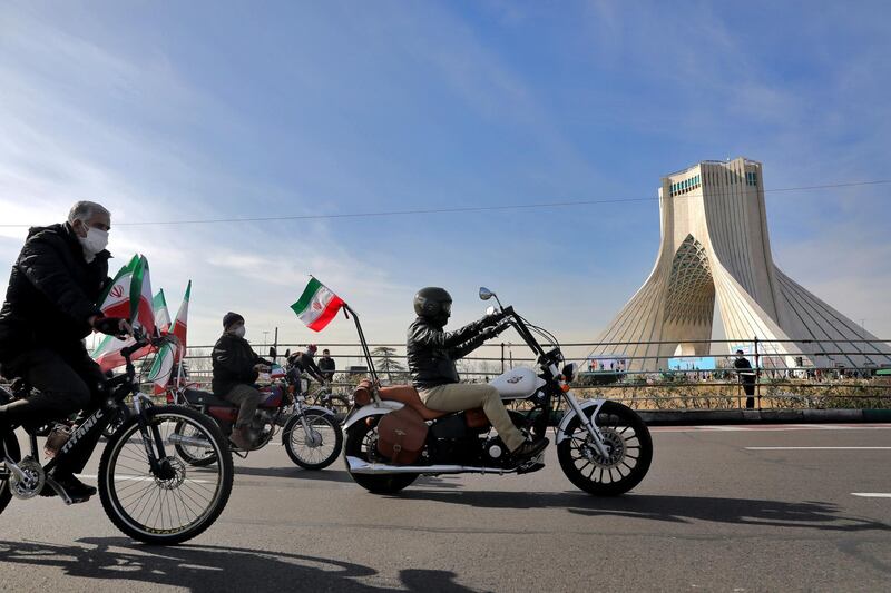 Iranians attend an annual rally at Azadi (Freedom) Square celebrating 42nd anniversary of Islamic Revolution, in Tehran, Iran, Wednesday, Feb. 10, 2021. Iranians Wednesday began a vehicle-only rallies in cities and towns across the country to mark the anniversary of its 1979 Islamic Revolution. The decision for replacing traditional rallies and demonstrations by vehicle-only move came as a measure to prevent spread of the coronavirus as the country struggles to stem the worst outbreak of the pandemic in the Middle East with death toll nearing 59,000 and some 1.48 million confirmed cases of the virus. The country on Tuesday launched a coronavirus inoculation campaign. (AP Photo/Ebrahim Noroozi)