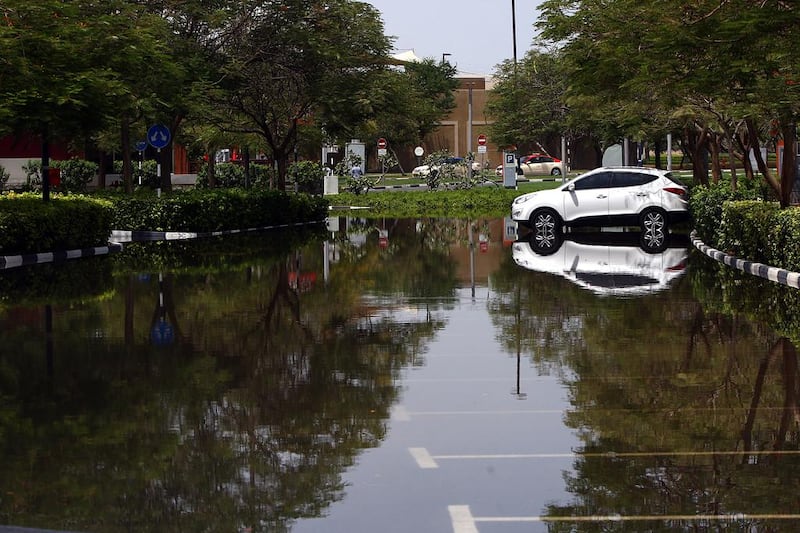 Hundreds of people were stranded for hours at Ibn Battuta Mall after a burst main pipe left their cars submerged in water near Discovery Gardens. Satish Kumar / The National 