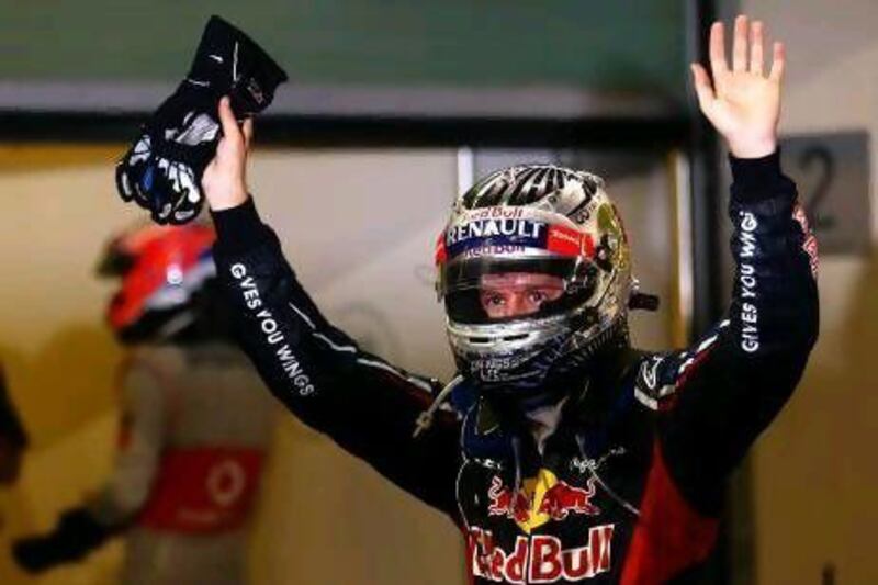 Sebastian Vettel waves to the crowd at the end of the race after a thrilling comeback drive at Yas Marina Circuit. Paul Gilham/ Getty Images