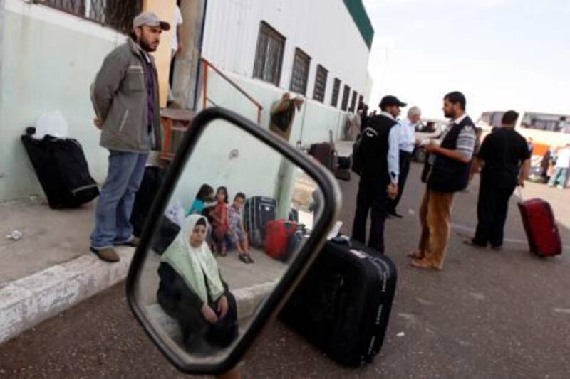 Palestinians wait to cross into Egypt through the Rafah border crossing in the southern Gaza Strip on May 28, 2011 as Egypt reopened the border, allowing people to cross freely for the first time in four years.         TOPSHOTS         AFP PHOTO/SAID KHATIB

 *** Local Caption ***  101337-01-08.jpg